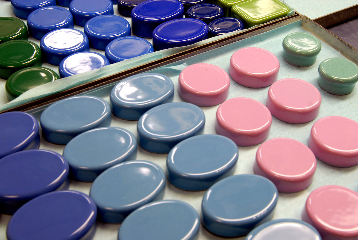 Image of enamel box bases faced down in Halcyon Days factory 