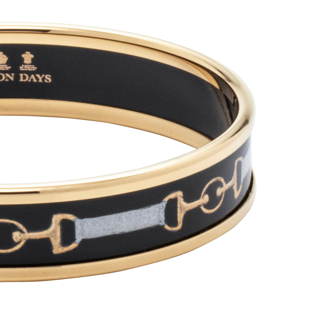 Close up of women's black enamel bangle with bridle design